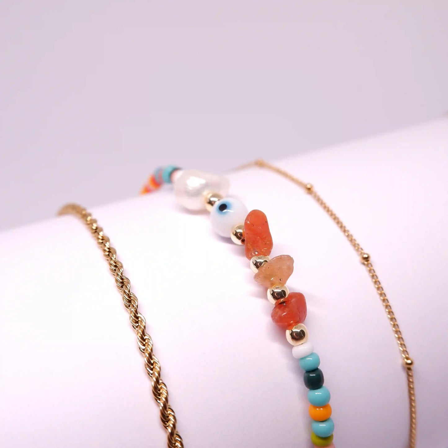 Discover the vibrant charm of the Ava Multicolour Anklet. A playful and colorful accessory that brings a splash of joy to any ensemble. This delightful anklet combines the whimsy of multicoloured plastic beads with the elegance of 18K gold-plated stainless steel charms, creating a piece that’s as versatile as it is beautiful.