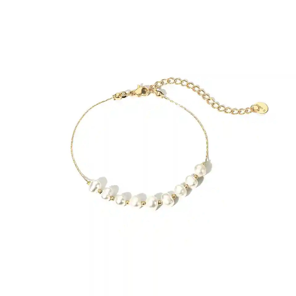 Introducing the Baroque Pearl Bracelet, a timeless piece of jewellery that exudes elegance and sophistication. Each bracelet is meticulously crafted with a generous 18K gold plating over robust stainless steel, ensuring both durability and a luxurious finish. Adorning this exquisite piece are lustrous pearls, carefully placed all around to create a seamless circle of radiance.